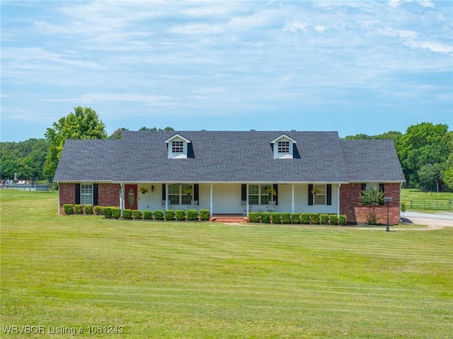 1205 S Division St, Lavaca, AR 72941 - new england style home with a porch, a front lawn, brick siding, and roof with shingles