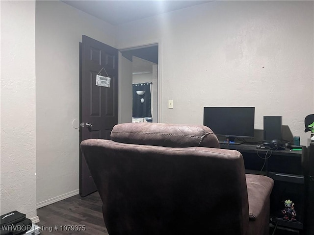 interior space with baseboards and dark wood-style flooring