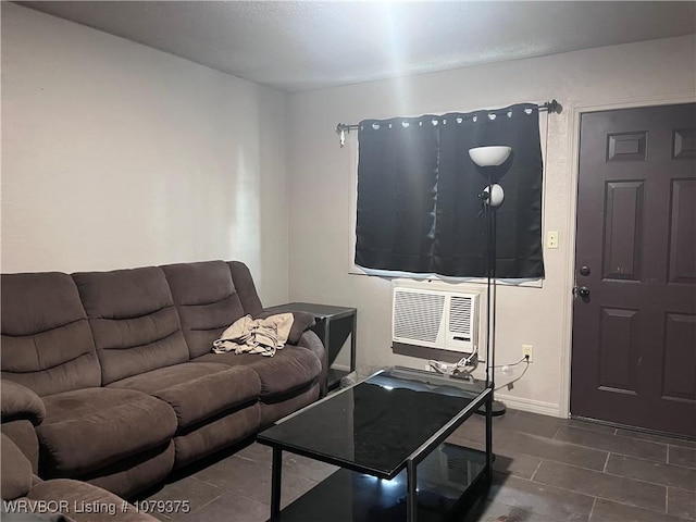 living area featuring a wall unit AC and baseboards