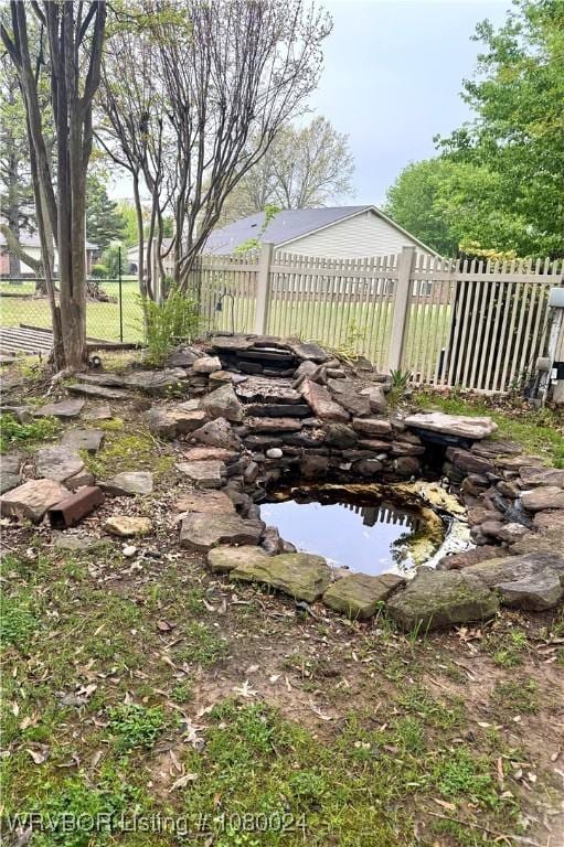 9704 Apple Gate Dr, Fort Smith, AR 72903 - view of yard with a small pond and fence