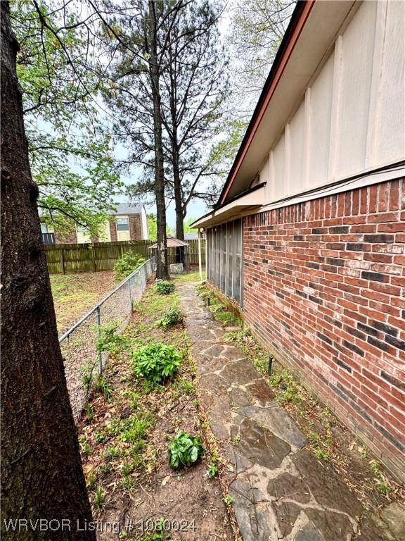 9704 Apple Gate Dr, Fort Smith, AR 72903 - view of side of property with brick siding, board and batten siding, and fence