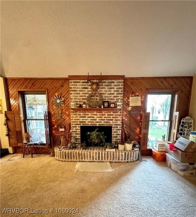 9704 Apple Gate Dr, Fort Smith, AR 72903 - carpeted living area featuring a high ceiling, wood walls, and a fireplace
