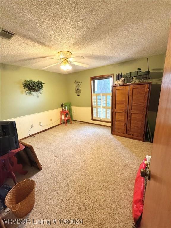 9704 Apple Gate Dr, Fort Smith, AR 72903 - interior space with a textured ceiling, carpet flooring, a ceiling fan, and visible vents