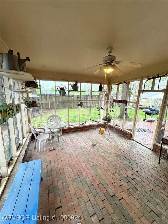 9704 Apple Gate Dr, Fort Smith, AR 72903 - unfurnished sunroom featuring brick floor and a ceiling fan