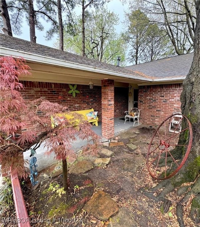 9704 Apple Gate Dr, Fort Smith, AR 72903 - exterior space featuring brick siding, a shingled roof, and a patio area