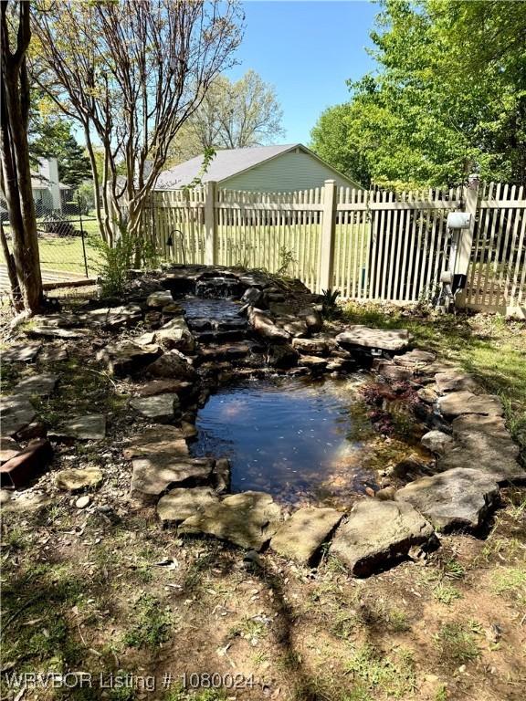9704 Apple Gate Dr, Fort Smith, AR 72903 - view of pool with a small pond and fence