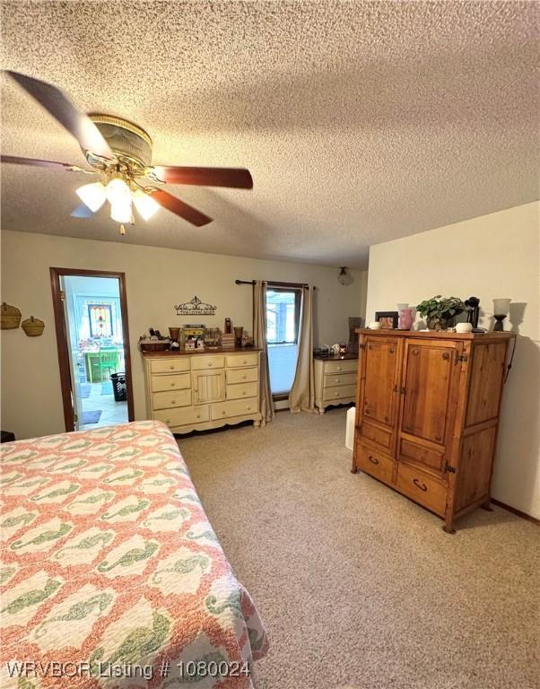 9704 Apple Gate Dr, Fort Smith, AR 72903 - bedroom with light carpet, a textured ceiling, and ceiling fan