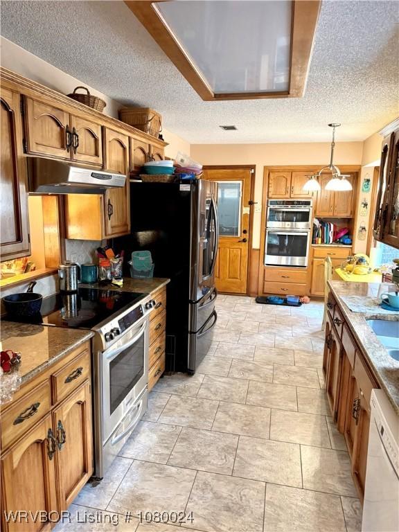 9704 Apple Gate Dr, Fort Smith, AR 72903 - kitchen featuring hanging light fixtures, a textured ceiling, appliances with stainless steel finishes, and under cabinet range hood