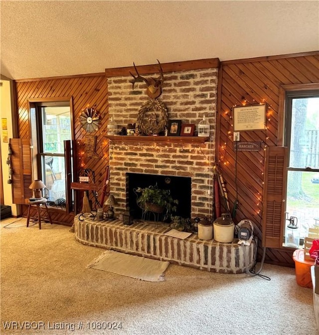 9704 Apple Gate Dr, Fort Smith, AR 72903 - carpeted living room featuring a textured ceiling, wooden walls, and a fireplace