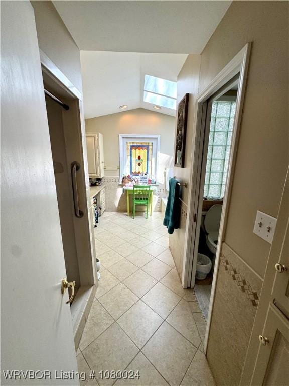 9704 Apple Gate Dr, Fort Smith, AR 72903 - corridor with a wealth of natural light, light tile patterned floors, and vaulted ceiling with skylight