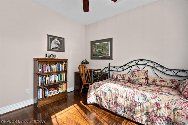 bedroom featuring wood finished floors, a ceiling fan, and baseboards