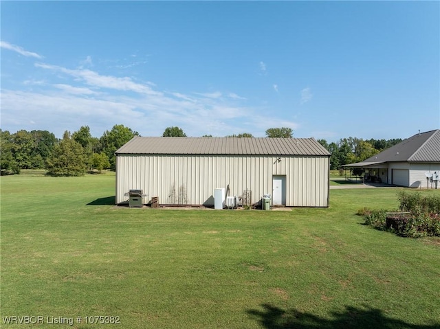 view of pole building with a garage and a lawn