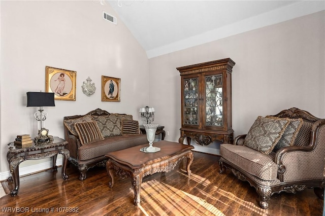 sitting room with high vaulted ceiling, wood-type flooring, visible vents, and baseboards