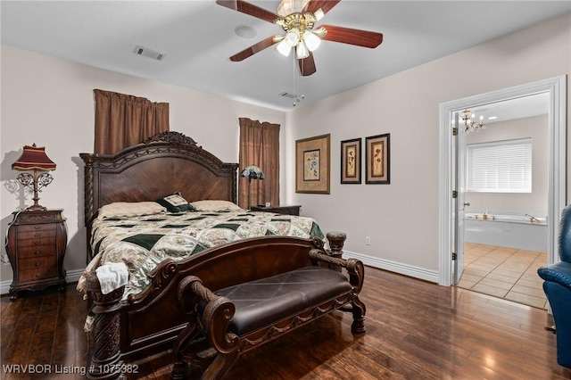 bedroom featuring ceiling fan with notable chandelier, wood finished floors, visible vents, and baseboards