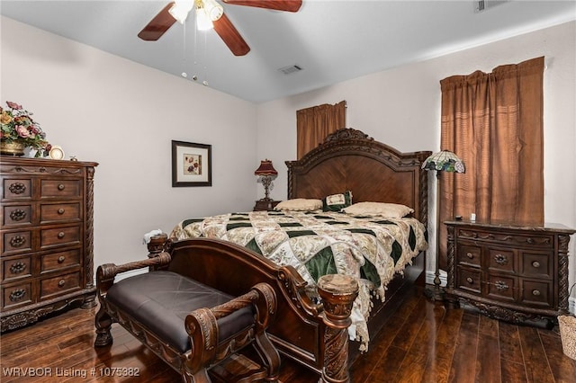 bedroom featuring dark wood-type flooring, visible vents, and a ceiling fan