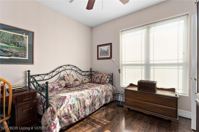 bedroom featuring ceiling fan, dark wood-type flooring, and baseboards