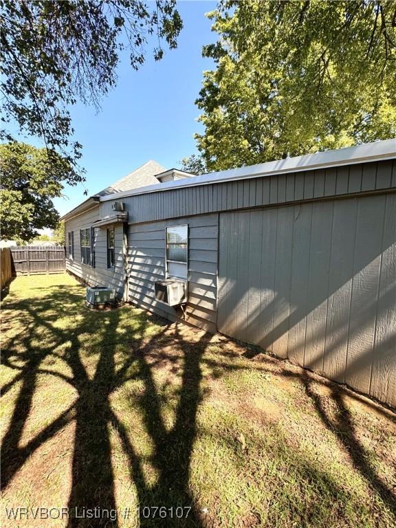 rear view of house featuring a yard