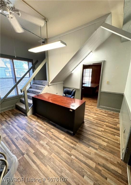 office space featuring hardwood / wood-style floors, ceiling fan, and vaulted ceiling