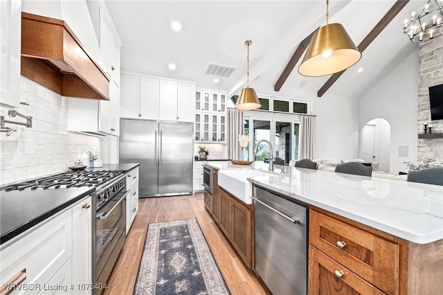 6801 Bentley Ridge Rdg, Fort Smith, AR 72903 - kitchen featuring white cabinets, a center island with sink, high end appliances, sink, and tasteful backsplash