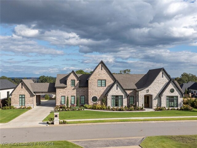 french country home featuring a front yard