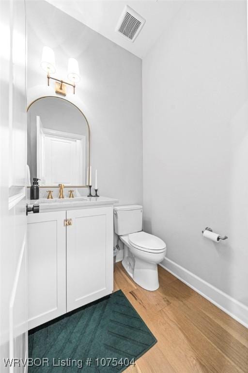 6801 Bentley Ridge Rdg, Fort Smith, AR 72903 - bathroom with wood-type flooring, vanity, and toilet