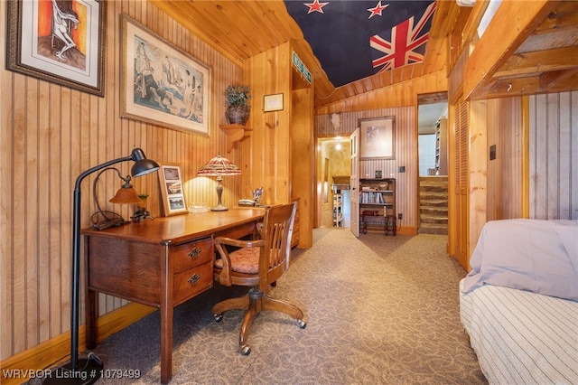 carpeted home office with lofted ceiling and wood walls