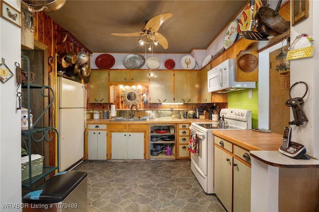 kitchen with white appliances, tile countertops, ceiling fan, a sink, and backsplash