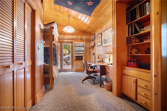 office area with carpet floors, lofted ceiling, wood walls, wooden ceiling, and a notable chandelier