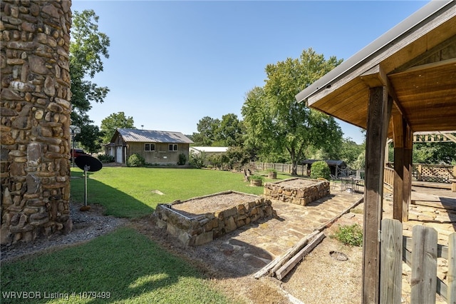 view of yard featuring an outdoor structure and fence