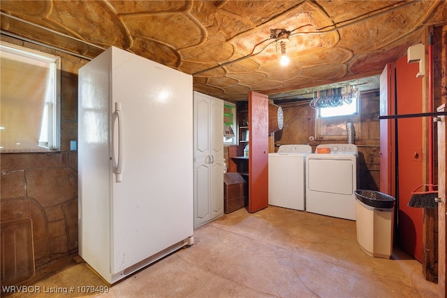 below grade area with freestanding refrigerator and separate washer and dryer