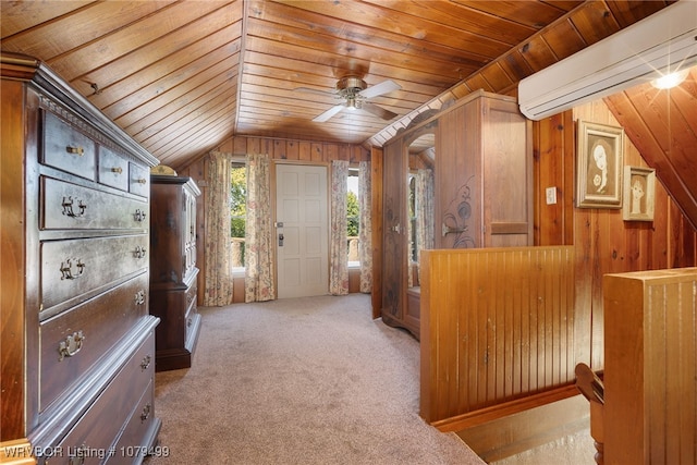 bonus room featuring a wall unit AC, a ceiling fan, carpet floors, wood ceiling, and wood walls