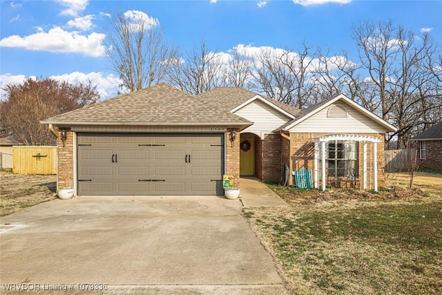 ranch-style home featuring brick siding, a shingled roof, concrete driveway, an attached garage, and fence