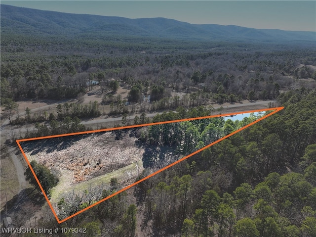 birds eye view of property featuring a wooded view