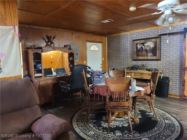 dining area featuring wood-type flooring, wooden walls, wooden ceiling, and brick wall