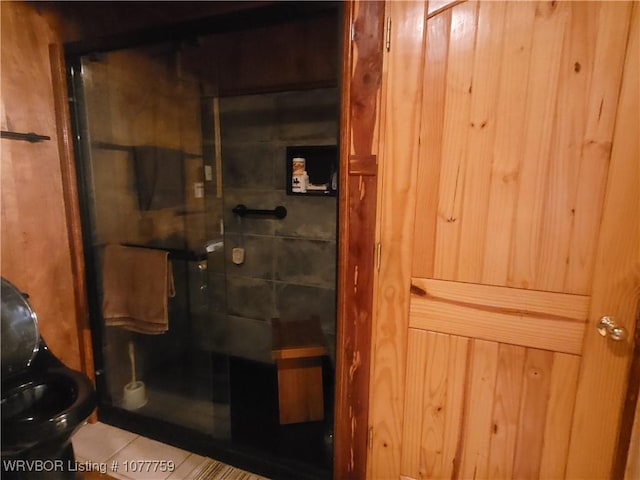 bathroom featuring wood walls