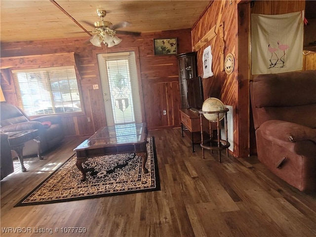 living room featuring wooden ceiling and wooden walls