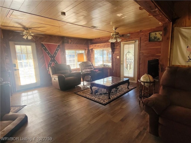 living room with wood-type flooring, ceiling fan, wooden walls, and wood ceiling