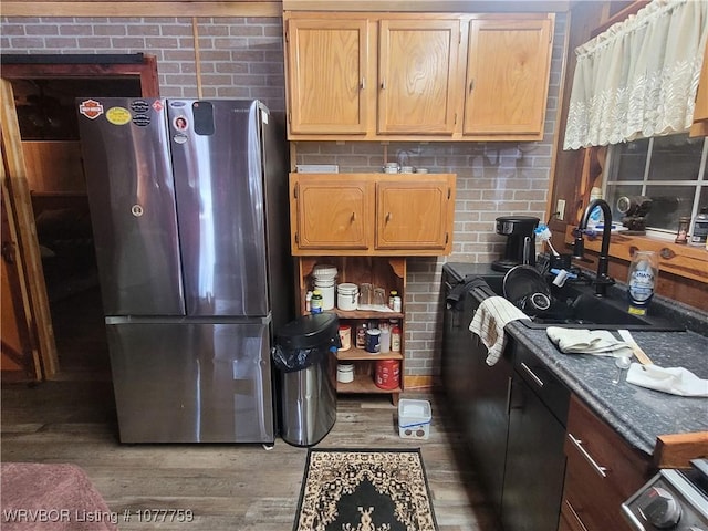 kitchen featuring stainless steel fridge, hardwood / wood-style flooring, and sink