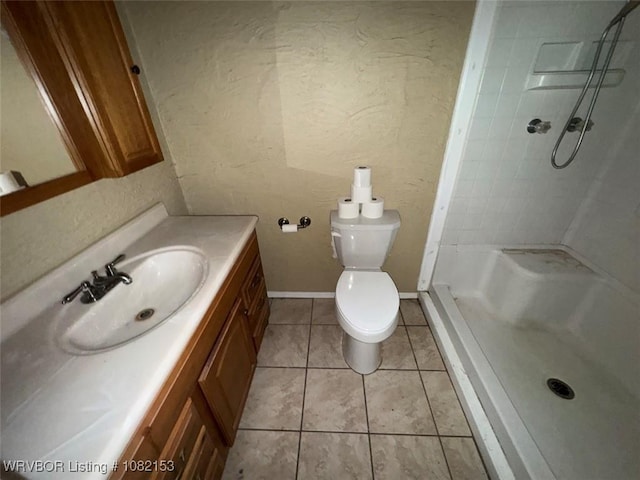 412 7th St, Barling, AR 72923 - bathroom featuring vanity, a shower, tile patterned flooring, and a textured wall