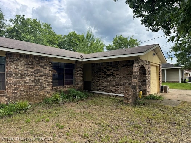 412 7th St, Barling, AR 72923 - view of side of property with a garage, brick siding, and concrete driveway
