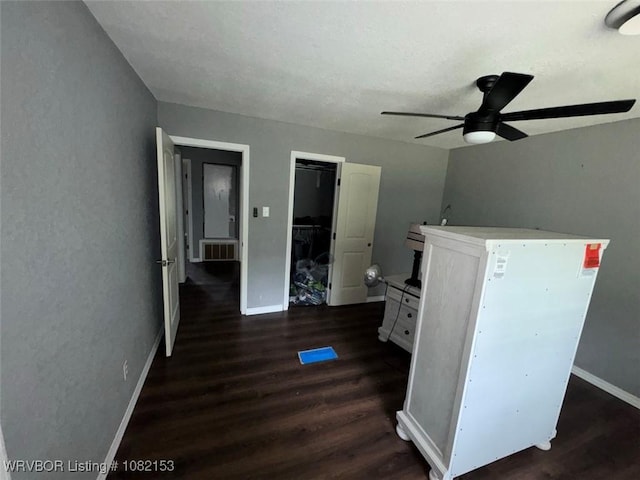 412 7th St, Barling, AR 72923 - unfurnished bedroom featuring dark wood-type flooring and a ceiling fan