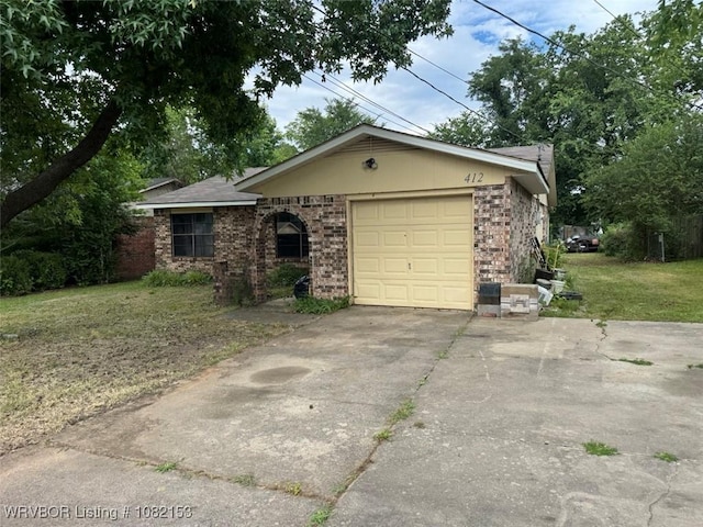 412 7th St, Barling, AR 72923 - ranch-style home featuring a front yard, concrete driveway, an attached garage, and brick siding