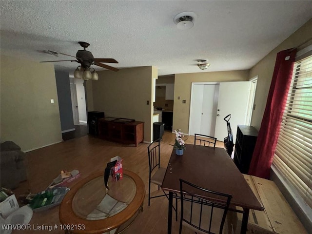 412 7th St, Barling, AR 72923 - dining room with wood finished floors, ceiling fan, and a textured ceiling
