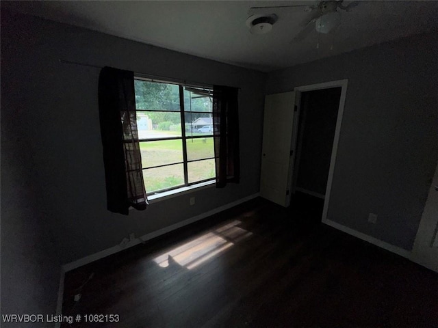 412 7th St, Barling, AR 72923 - empty room featuring baseboards and dark wood-type flooring