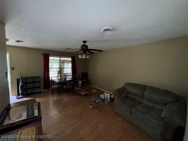 412 7th St, Barling, AR 72923 - living room with a textured ceiling, wood finished floors, and a ceiling fan