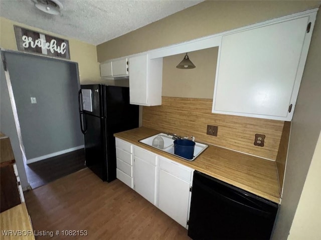 412 7th St, Barling, AR 72923 - kitchen featuring black appliances, decorative backsplash, white cabinetry, wood finished floors, and a textured ceiling