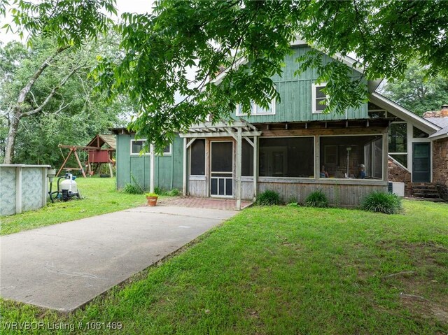 2650 Spielerville Rd, Paris, AR 72855 - rear view of house featuring a sunroom and a lawn