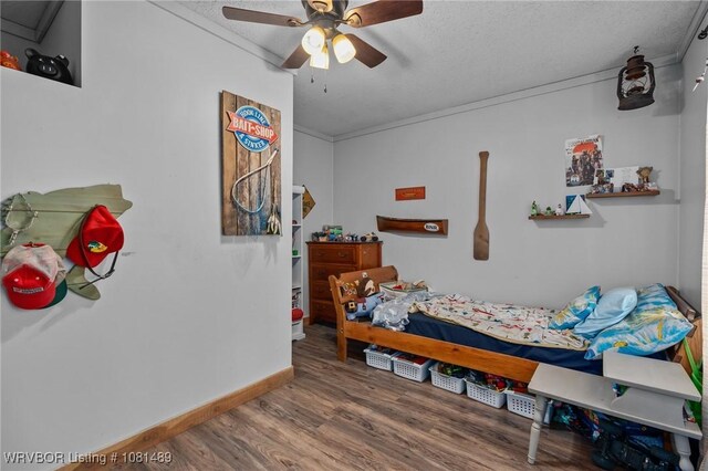 2650 Spielerville Rd, Paris, AR 72855 - bedroom with wood finished floors, a textured ceiling, baseboards, and ceiling fan