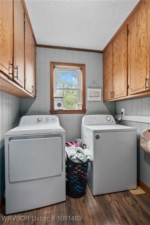 2650 Spielerville Rd, Paris, AR 72855 - laundry room with washing machine and dryer, cabinet space, wood finished floors, a textured ceiling, and crown molding