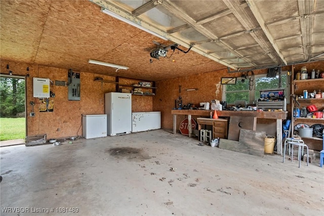 2650 Spielerville Rd, Paris, AR 72855 - garage with a workshop area, electric panel, and a garage door opener